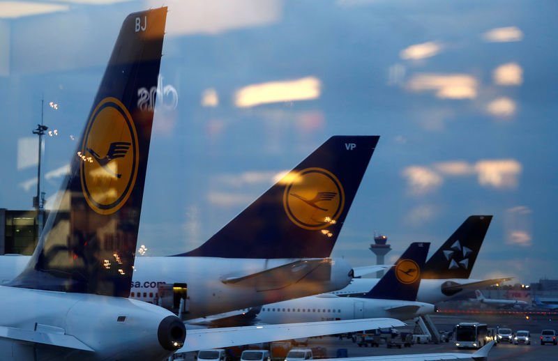 © Reuters. Tail wings of planes of German air carrier Lufthansa are seen from a cafe bar at the airport in Frankfurt