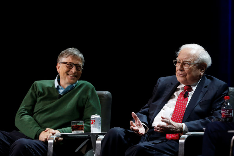 © Reuters. Warren Buffett, chairman and CEO of Berkshire Hathaway, speaks while Bill Gates looks on at Columbia University in New York