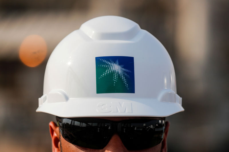 © Reuters. FILE PHOTO:  An employee in a branded helmet is pictured at Saudi Aramco oil facility in Abqaiq