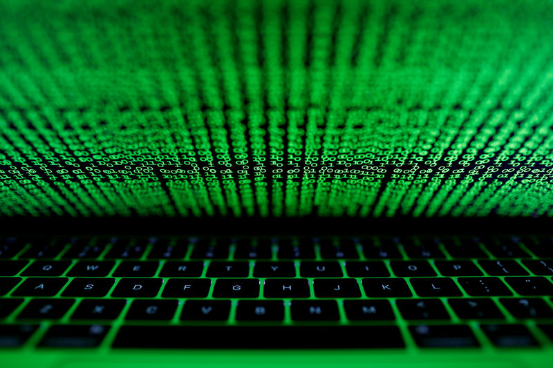 © Reuters. FILE PHOTO: A computer keyboard lit by a displayed cyber code is seen in this illustration picture