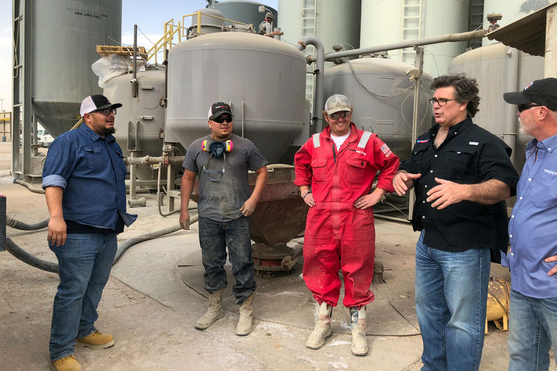 © Reuters. FILE PHOTO: Redman, CEO of ProPetro, speaks with workers in Midland