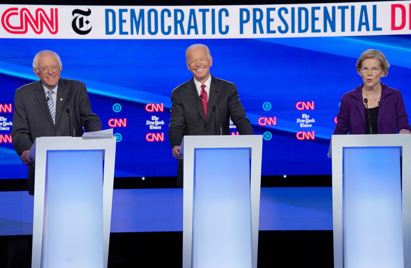 © Reuters. FILE PHOTO: Democratic presidential candidates Senator Bernie Sanders and former Vice President Joe Biden listen to Senator Elizabeth Warren as they debate during the fourth U.S. Democratic presidential candidates 2020 election debate in Westerville, Ohio