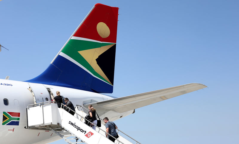 © Reuters. FILE PHOTO: Passengers board a South African Airways plane at the Port Elizabeth International Airport in the Eastern Cape province