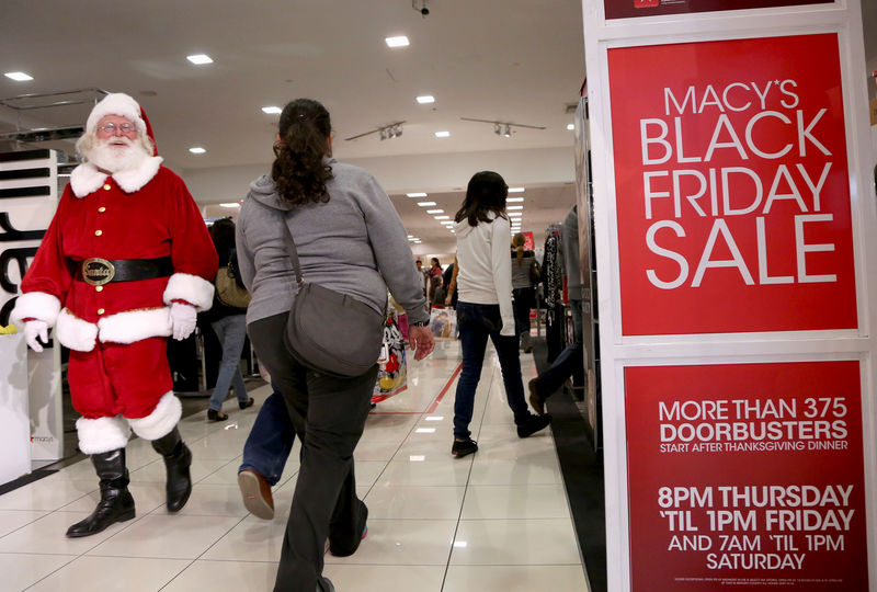 © Reuters. FILE PHOTO: A Santa Claus walks with Black Friday shoppers inside a Macy's store at the Glendale Galleria in Glendale, California