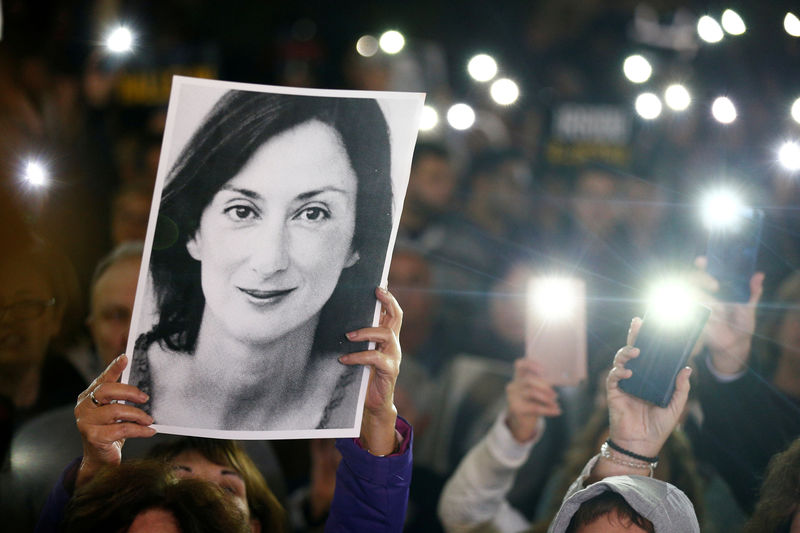 © Reuters. FILE PHOTO: People gather at the Great Siege Square calling for the resignation of Joseph Muscat, in Valletta