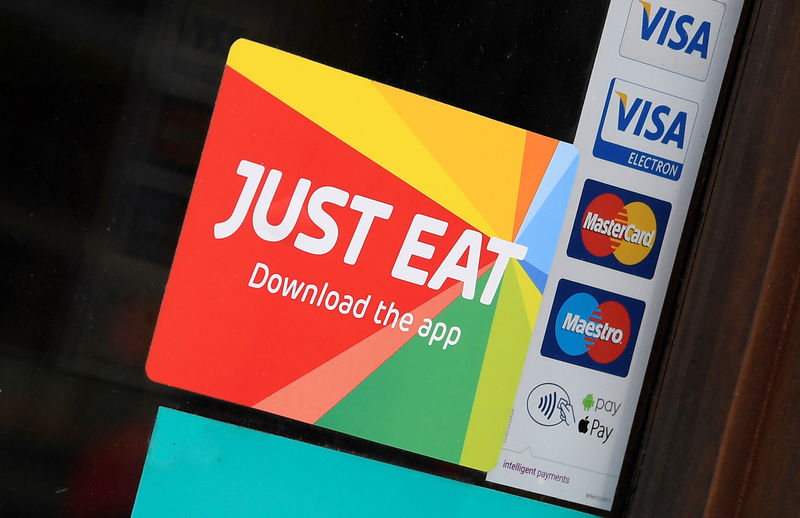 © Reuters. FILE PHOTO: Signage for Just Eat is seen on the window of a restaurant in London