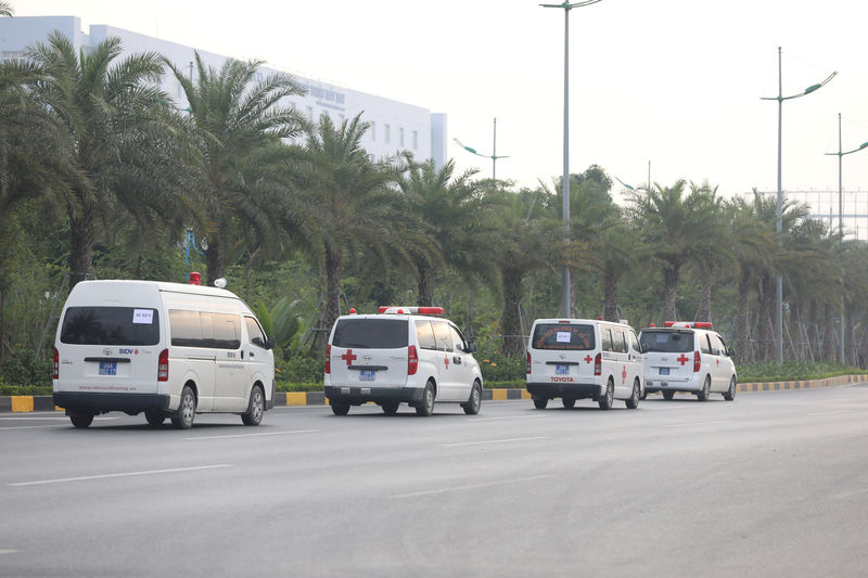 © Reuters. Ambulances from Ha Tinh province are seen while allegedly carrying some of the bodies of victims on 39 deaths on a truck container in UK, leave Noi Bai airport in Hanoi