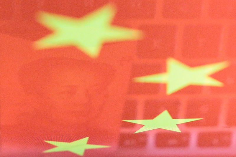 © Reuters. Illustration picture of China yuan banknote and computer keyboard reflected on Chinese flag