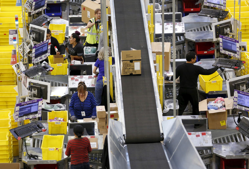 © Reuters. FILE PHOTO: Workers prepare orders at the Amazon Fulfillment Center in Tracy