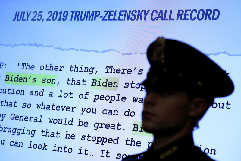 © Reuters. FILE PHOTO: A Capitol Hill Police officer is silhouetted before a Trump-Zelensky call record at the House Intelligence Committee hearing as part of Trump impeachment inquiry on Capitol Hill in Washington
