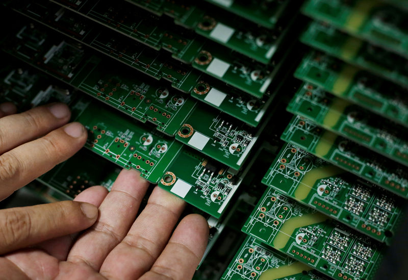 © Reuters. FILE PHOTO: An employee works on the production line of a television factory under Zhaochi Group in Shenzhen
