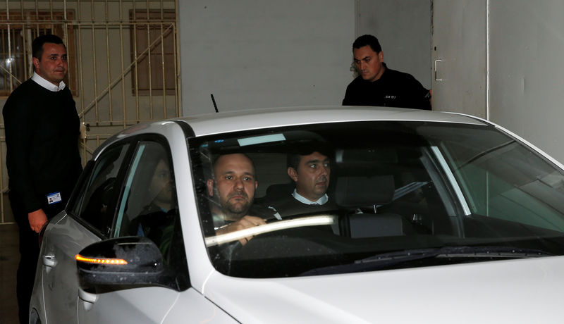 © Reuters. Melvin Theuma, who allegedly acted as a middle man in a plot to murder of journalist Daphne Caruana Galizia, is seen in a police car as he leaves the Courts of Justice in Valletta