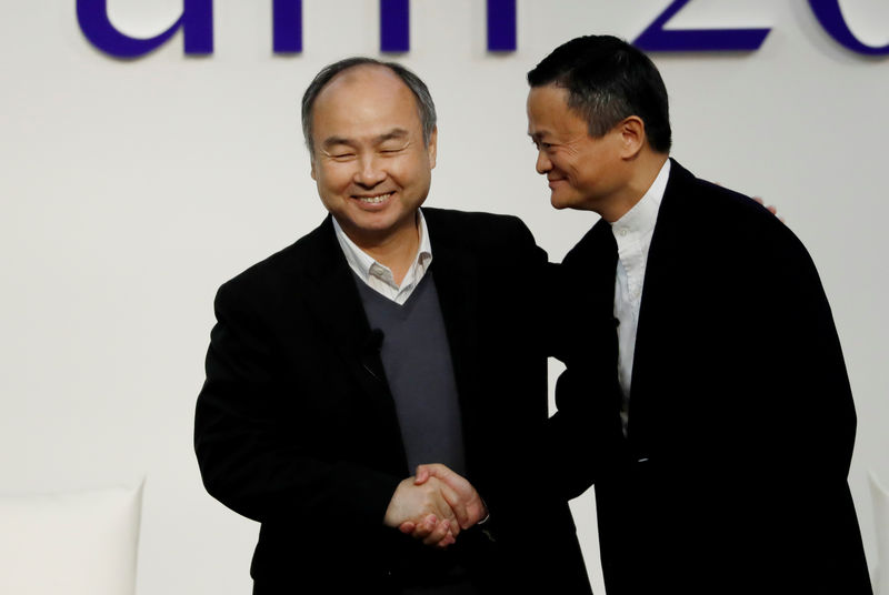 © Reuters. SoftBank Group founder and CEO Masayoshi Son and Alibaba founder and former Chairman Jack Ma shake hands at the Tokyo Forum 2019 in Tokyo