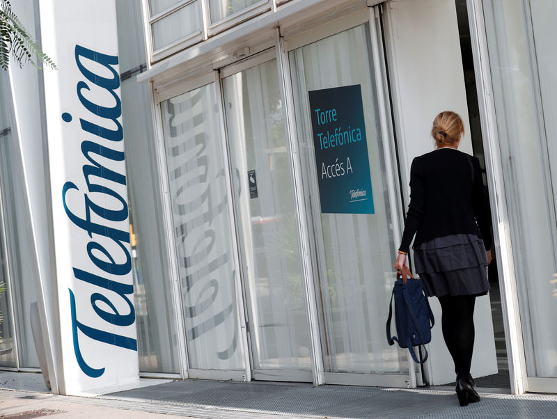 © Reuters. FILE PHOTO: A woman walks into a Telefonica office building in Barcelona