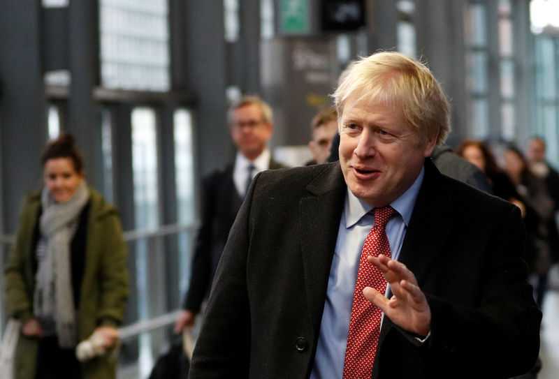 © Reuters. FILE PHOTO:  Britain's Prime Minister Boris Johnson arrives on the platform to board a train in London
