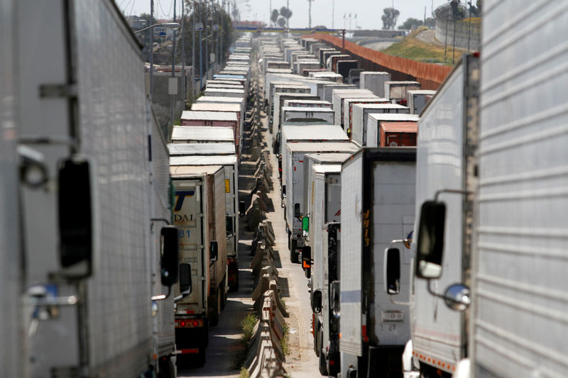 © Reuters. FILE PHOTO: Trucks wait in a long queue for border customs control to cross into the U.S., caused by the redeployment of border officers to deal with a surge in migrants, at the Otay border crossing in Tijuana