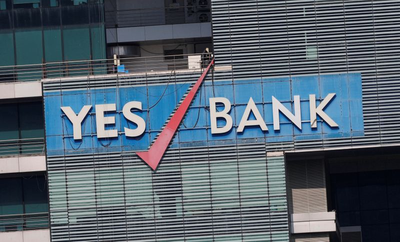 © Reuters. FILE PHOTO:  The logo of Yes Bank is pictured on the facade of its headquarters in Mumbai