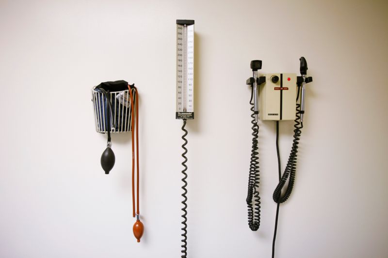 © Reuters. Devices used to take blood pressure, temperature, and examine eyes and ears rest on a wall inside of a doctor's office in New York