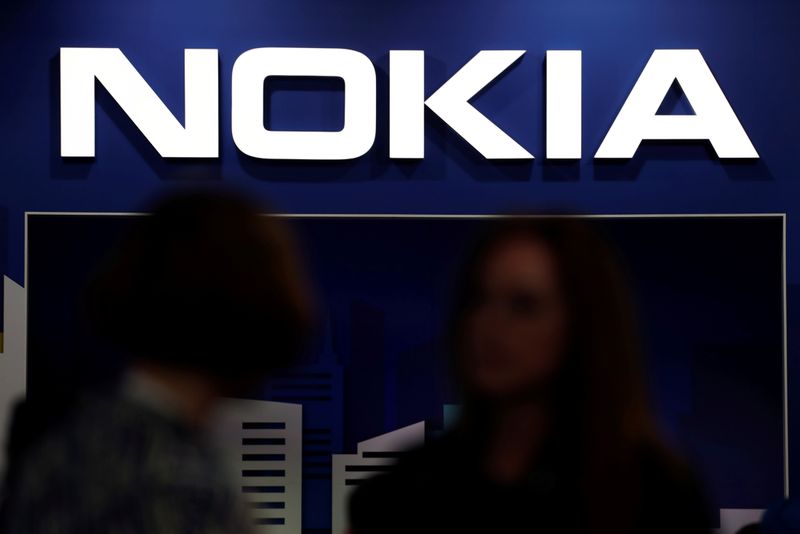 © Reuters. FILE PHOTO: Visitors gather outside the Nokia booth at the Mobile World Congress in Barcelona, Spain