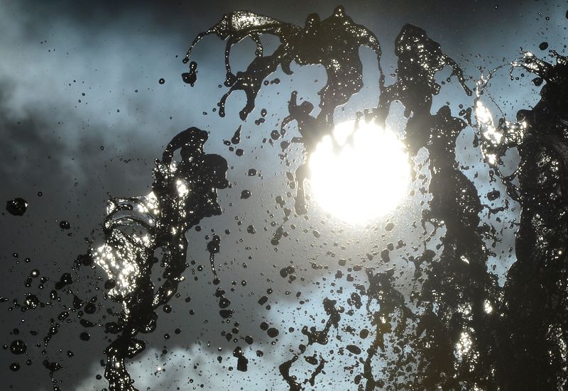 © Reuters. The sun shines as water squirts from a fountain in London