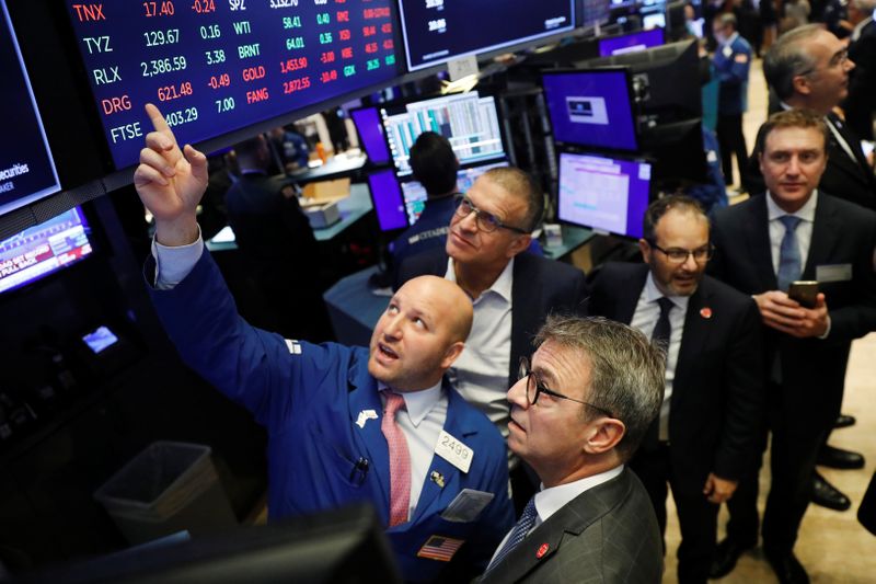 © Reuters. FILE PHOTO: CEO of Kaleyra, Dario Calogero, looks up at a board before the company's IPO above the floor of NYSE shortly after the opening bell in New York