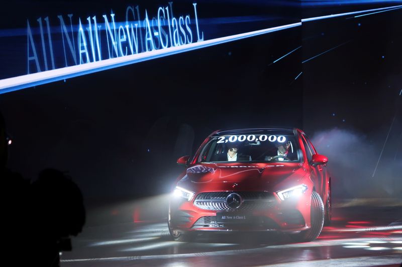 © Reuters. Staff members drive a Mercedes-Benz A Class L Sedan on the stage during an event marking the start of production of the sedan at a Beijing Benz Automotive Co (BBAC) plant in Beijing