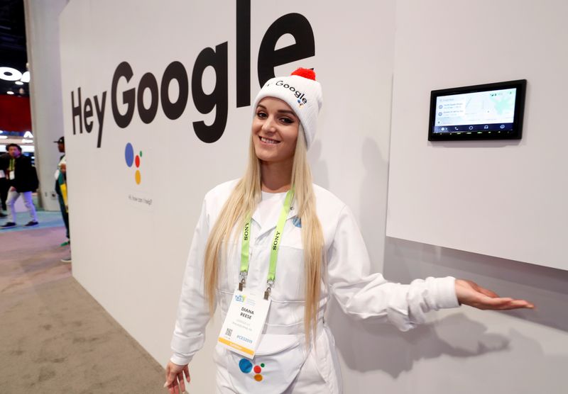 © Reuters. Demonstrator Diana Reese poses by an auto infotainment system equipped with Google Assistant in the JVC-Kenwood booth during the 2019 CES in Las Vegas