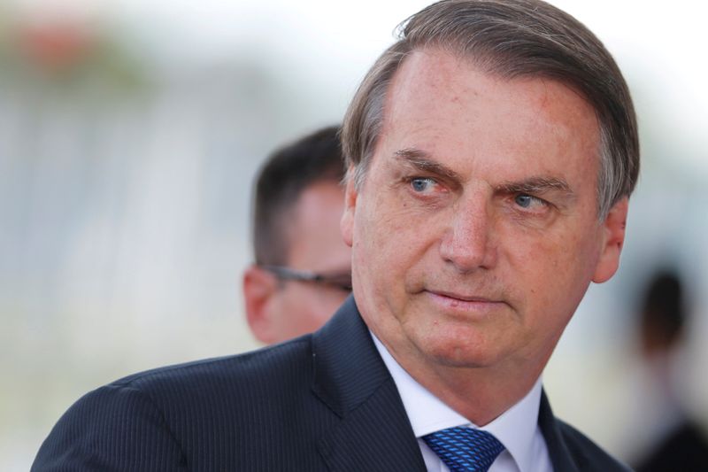 © Reuters. FILE PHOTO: Brazil's President Jair Bolsonaro looks on as he leaves the Alvorada Palace in Brasilia