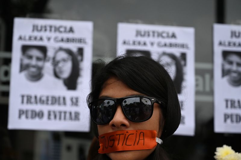 © Reuters. A woman protests outside a closed McDonald's restaurant, after the the deaths of two teenaged employees, in Lima