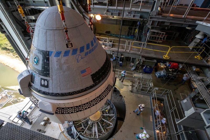 © Reuters. The Boeing CST-100 Starliner spacecraft is guided into position above a United Launch Alliance Atlas V rocket at Cape Canaveral
