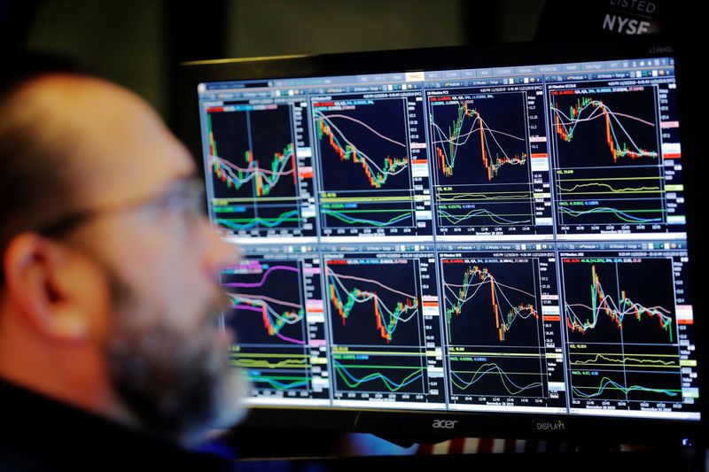© Reuters. FILE PHOTO:  A trader works on the floor of the New York Stock Exchange shortly after the opening bell in New York City
