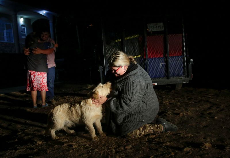 © Reuters. Laura Garcia hugs her dog after arriving home, in Jalpan de Serra