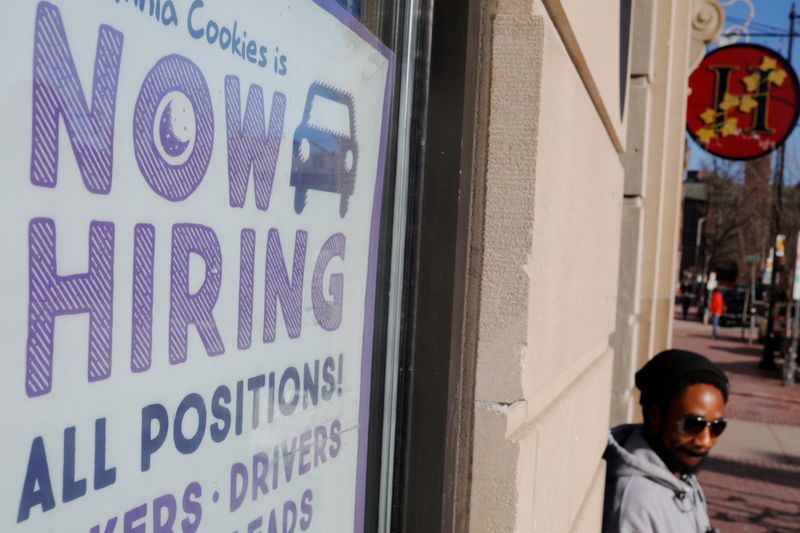 © Reuters. A "Now Hiring" sign sits in the window of Insomnia Cookies in Cambridge