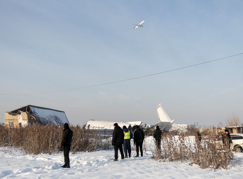 © Reuters. El personal de emergencia y seguridad es visto en el lugar del accidente aéreo cerca de Almaty, Kazajstán