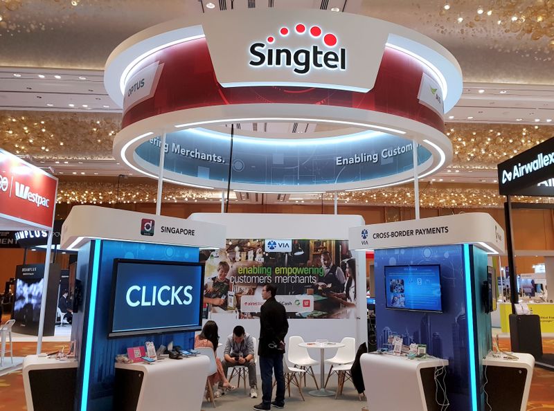 © Reuters. FILE PHOTO: A Singtel booth is pictured at the Money 20/20 Asia Fintech Trade Show in Singapore