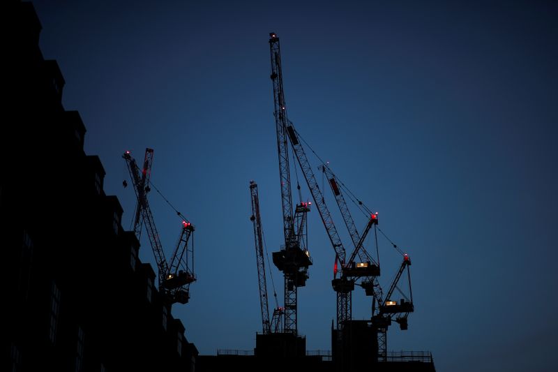 © Reuters. FILE PHOTO:  Construction cranes are seen on a building site at sunrise in central London