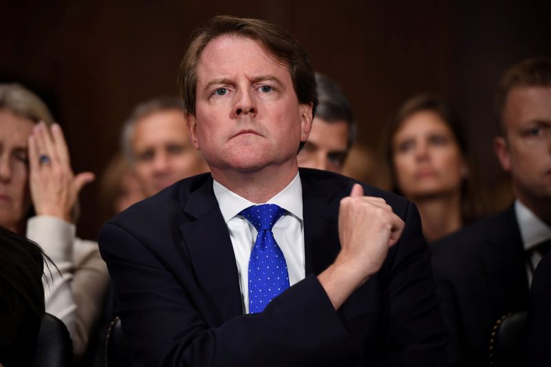 © Reuters. FILE PHOTO: White House Counsel Don McGahn listens to Supreme Court nominee Brett Kavanaugh as he testifies before the US Senate Judiciary Committee on Capitol Hill in Washington