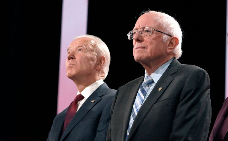 © Reuters. Former Vice President Joe Biden and Senator Bernie Sanders stand together on stage before the start of the sixth 2020 U.S. Democratic presidential candidates campaign debate at Loyola Marymount University in Los Angeles