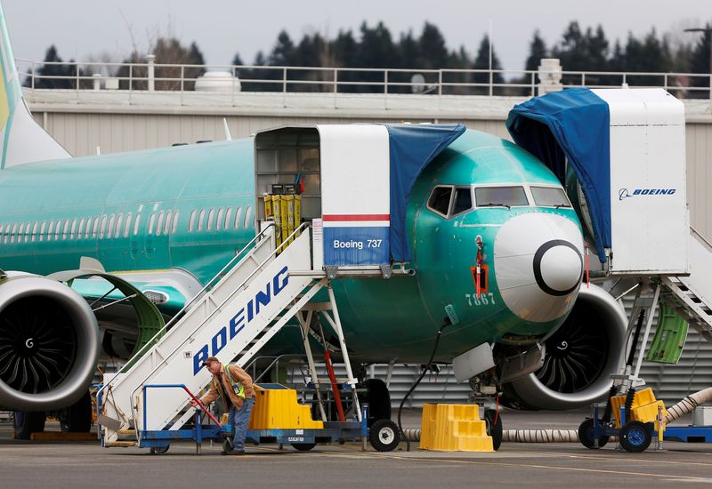 © Reuters. FILE PHOTO: An employee works near a Boeing 737 Max aircraft at Boeing's 737 Max production facility in Renton