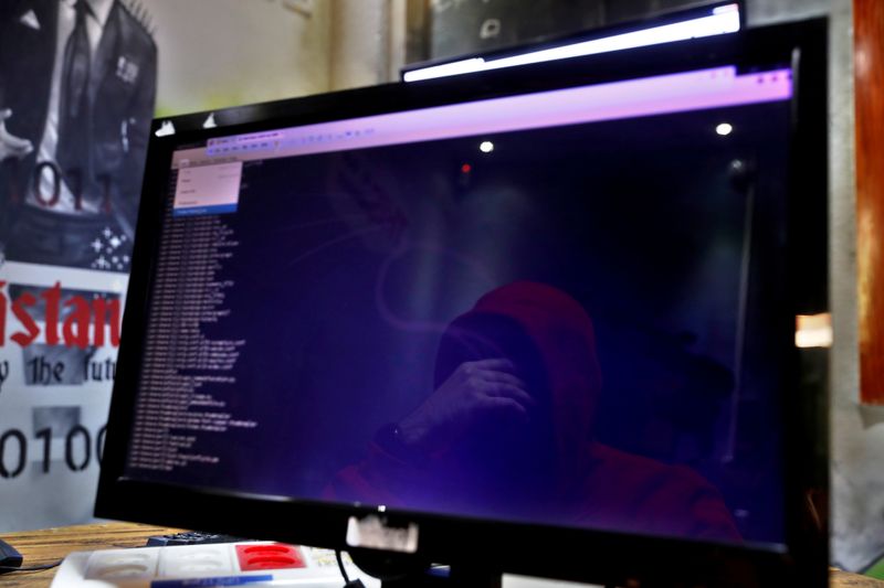 © Reuters. FILE PHOTO: A man is reflected in a monitor as he takes part in a training session at Cybergym, a cyber-warfare training facility backed by the Israel Electric Corporation, at their training center in Hadera, Israel