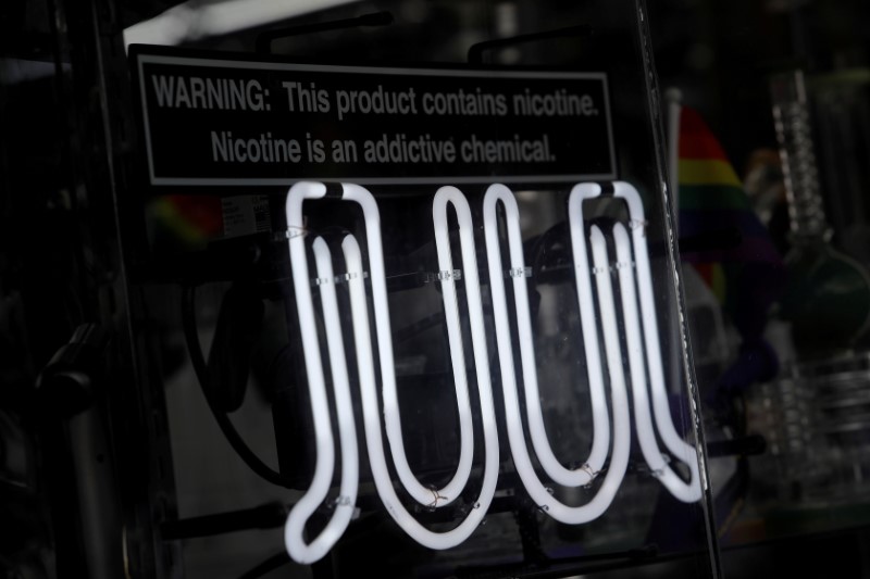 © Reuters. FILE PHOTO: Signage for Juul vaping products is seen on a storefront in New York City
