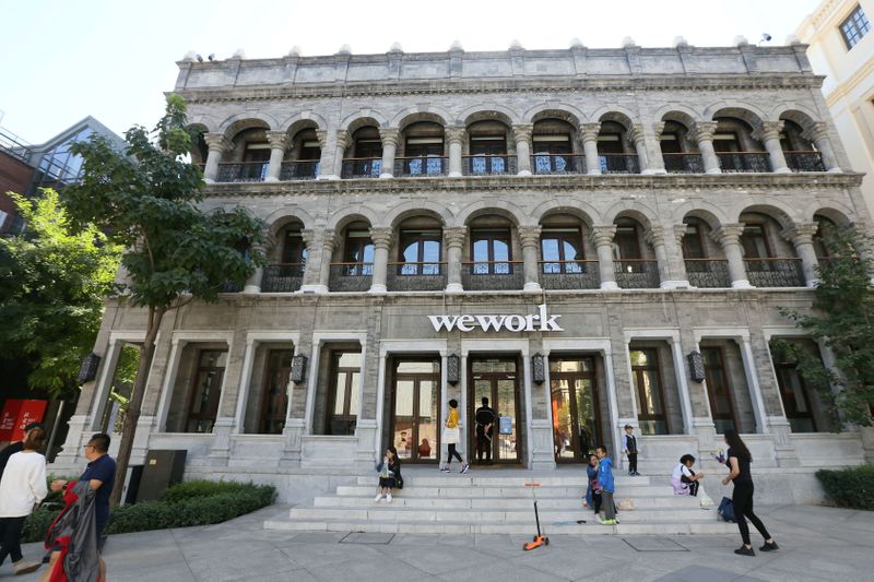 © Reuters. People are seen outside the building of Wework's co-working space during the National Day Golden Week holiday in central Beijing