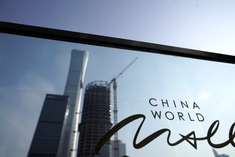 © Reuters. The sign of China World is seen near buildings in Beijing's central business area