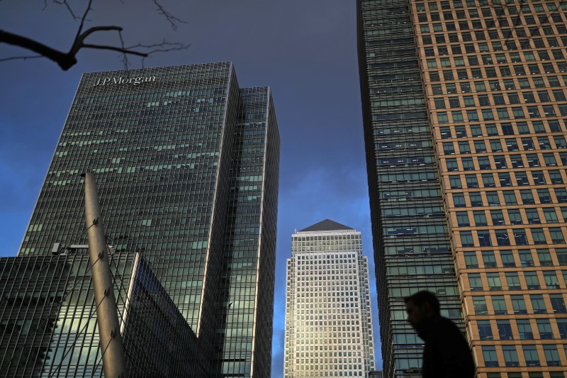 © Reuters. A person walks through the Canary Wharf financial district of London