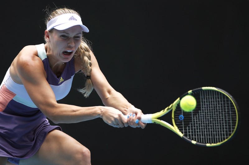 Wozniacki battles 'mixed emotions' in first round win at Australian Open