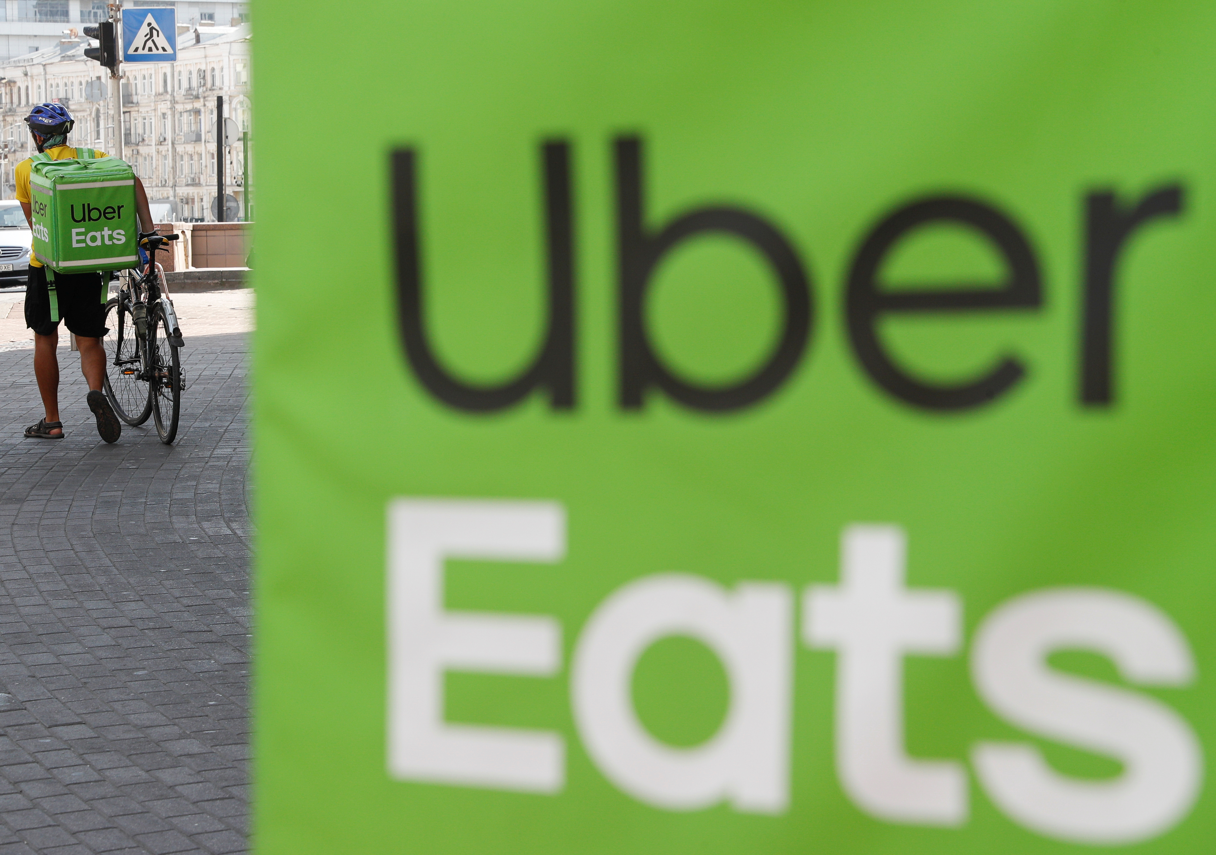 © Reuters. An Uber Eats courier walks in Kiev