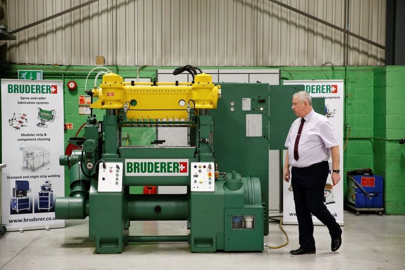 © Reuters. Service Manager of Bruderer Uk Ltd Mark Crawford, inspects a machine at the company's factory in Luton