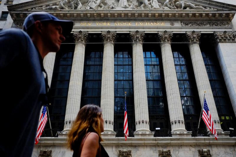 © Reuters. People walk by New York Stock Exchange in the financial district in New York