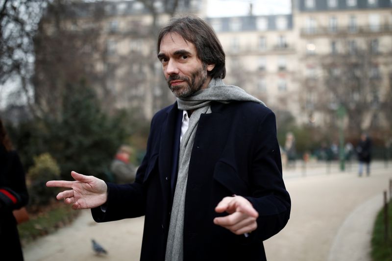 © Reuters. French mathematician Cedric Villani, member of Parliament and candidate for Paris mayoral election, campaigns in Paris