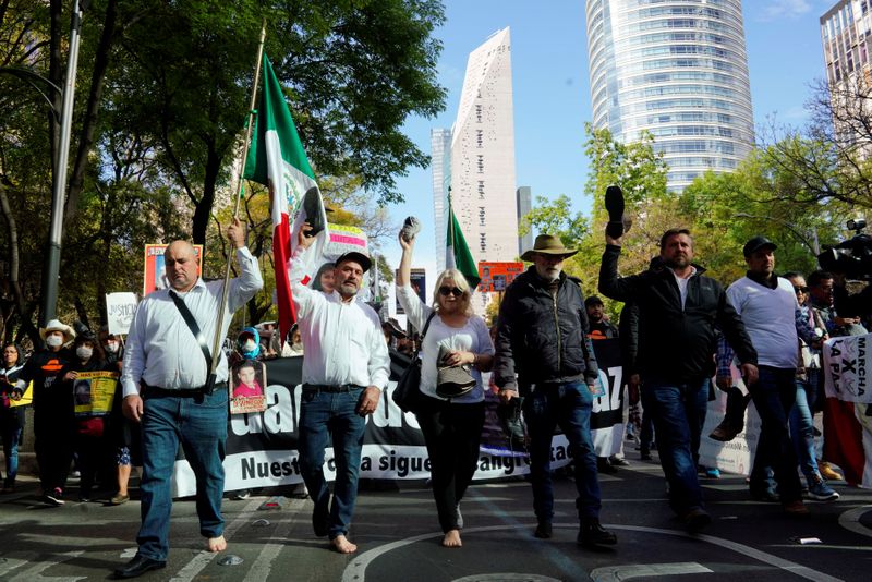 © Reuters. Humans rights activists: Julien LeBaron, Adrian LeBaron, Shalom Tucker, Javier Sicilia and Lenzo Widmar march during a protest against violence in Mexico City